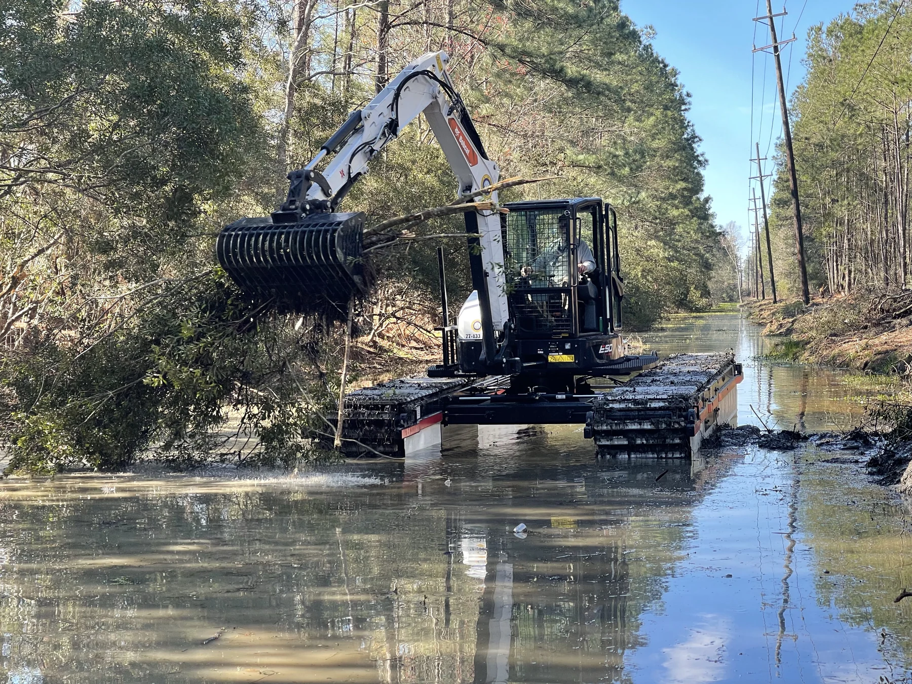 Excavator operating from a floating work platform.